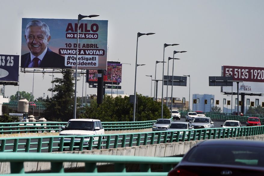 A billboard featuring Mexico&#39;s President Andres Manuel Lopez Obrador with a message encouraging citizens to get out and vote towers over a highway in Mexico City, Saturday, March 26, 2022. On April 10, a presidential recall referendum will be held to revalidate his administration after three years in office. Mexicans will be asked if they want the president to continue in office until 2024 or resign. (AP Photo/Marco Ugarte)