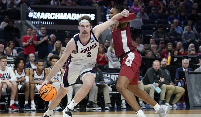 Gonzaga forward Drew Timme, left, drives to the basket against Arkansas guard Stanley Umude during the second half of a college basketball game in the Sweet 16 round of the NCAA tournament in San Francisco, Thursday, March 24, 2022. (AP Photo/Marcio Jose Sanchez) **FILE**