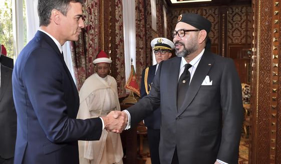 FILE - This photo provided by the Moroccan Royal Palace shows Spanish Prime Minister Pedro Sanchez, left, greeted by Moroccan King Mohammed VI prior to their lunch at the Royal Palace in Rabat, Morocco, Nov. 19, 2018. Sanchez is set to meet with Moroccan King Mohammed VI on Thursday, April 7, 2022 during a two-day visit to Rabat that promises to mark a mending of diplomatic tensions centered on the disputed region of Western Sahara. Relations were damaged last April when Morocco was angered by Spain allowing the leader of the pro-independence movement for Western Sahara to receive medical treatment. (Moroccan Royal Palace via AP, File)