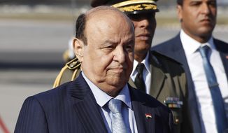 FILE - Yemen&#39;s President Abed Rabbo Mansour Hadi walks next of his Tunisian counterpart Beji Caid Essebsi, not in photo, upon his arrival at Tunis-Carthage international airport to attend the Arab Summit, in Tunis, Tunisia, March 30, 2019. Yemen’s exiled president stepped aside and transferred his powers to a presidential council on Thursday, April 7, 2022, as international and regional efforts to end the country’s long-running civil war gained momentum with a two-month truce.(AP Photo/Hussein Malla, File)