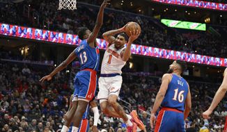 New York Knicks forward Obi Toppin (1) goes to the basket against Washington Wizards center Thomas Bryant (13) and forward Anthony Gill (16) during the second half of an NBA basketball game Friday, April 8, 2022, in Washington. (AP Photo/Nick Wass)