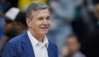 North Carolina Gov. Roy Cooper leaves the court following an NBA basketball game between the Charlotte Hornets and Orlando Magic on Thursday, April 7, 2022, in Charlotte, N.C. (AP Photo/Rusty Jones) ** FILE **