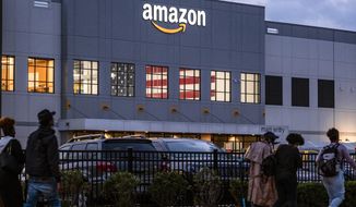 FILE - People arrive for work at the Amazon distribution center in the Staten Island borough of New York, on Oct. 25, 2021. Amazon plans to file objections to the union election on Staten Island, N.Y., that resulted in the first successful U.S. organizing effort in the company’s history. The e-commerce giant stated its plans in a legal filing to the National Labor Relations Board made public Thursday, April 7, 2022. (AP Photo/Craig Ruttle, File)