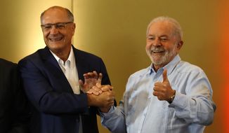 Former Brazilian President Luiz Inacio Lula da Silva, with the Workers&#39; Party, right, and former Sao Paulo Governor Geraldo Alckmin, with Brazilian Socialist Party, pose for photos during a campaign event in Sao Paulo, Brazil, Friday, April 8, 2022. Lula da Silva signaled that he will choose his former rival as his running mate in October&#39;s election. (AP Photo/Marcelo Chello)