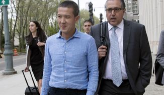 FILE —Former Goldman Sachs executive Roger Ng, center, leaves Brooklyn Federal court with attorney Marc Agnifilo, right, May 6, 2019, in New York. A U.S. jury convicted Ng on all counts in $4.5 billion scheme to loot Malaysian fund 1MDB, Friday, April 8, 2022. (AP Photo/Mary Altaffer, File)