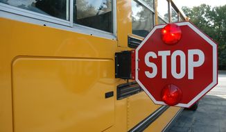 School bus with stop sign. Photo credit: Jerry Horbert via Shutterstock. FILE