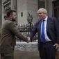 In this image provided by the Ukrainian Presidential Press Office, Ukrainian President Volodymyr Zelenskyy, left, and Britain&#39;s Prime Minister Boris Johnson, shake hands during their walk in downtown Kyiv, Ukraine, Saturday, April 9, 2022. (Ukrainian Presidential Press Office via AP)