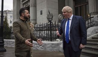 In this image provided by the Ukrainian Presidential Press Office, Ukrainian President Volodymyr Zelenskyy, left, and Britain&#39;s Prime Minister Boris Johnson talk during their walk in downtown Kyiv, Ukraine, Saturday, April 9, 2022. (Ukrainian Presidential Press Office via AP)
