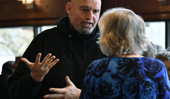 Pennsylvania Lt. Gov. John Fetterman, left, who is running for the Democratic nomination for U.S. Senate, speaks to an attendee at a Centre County Democrats&#39; breakfast event at a hotel at the Mountain View Country Club, Saturday, April 9, 2022, in Boalsburg, Pa. (AP Photo/Marc Levy)