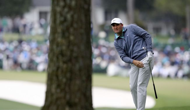 Scottie Scheffler watches his second shot on the first fairway during the third round of the Masters golf tournament at Augusta National on Saturday, April 9, 2022, in Augusta, Ga. (Curtis Compton/Atlanta Journal-Constitution via AP)