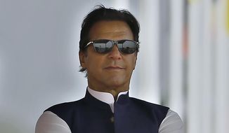 FILE - Pakistan&#39;s Prime Minister Imran Khan attends a military parade to mark Pakistan National Day, in Islamabad, Pakistan on March 23, 2022. Pakistan’s embattled prime minister faces a tough no-confidence vote Saturday, April 9, 2022, waged by his political opposition, which says it has the numbers to defeat him. (AP Photo/Anjum Naveed, File)