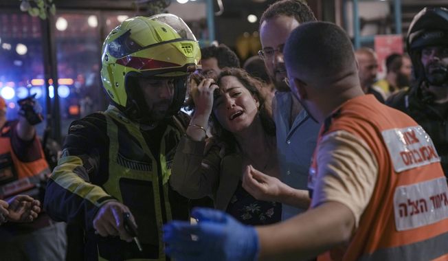 A woman reacts at the scene of a shooting attack In Tel Aviv, Israel, Thursday, April 7, 2022. Israeli health officials say two people were killed and at least eight others wounded in a shooting in central Tel Aviv. Israeli troops on Saturday raided the hometown of a Palestinian who carried out a deadly shooting in Tel Aviv, sparking a gunbattle in the occupied West Bank that left at least one Palestinian militant dead, according to Israeli and Palestinian accounts. (AP Photo/Ariel Schalit).  **FILE**