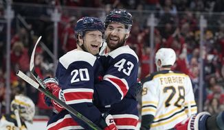 Washington Capitals center Lars Eller (20) celebrates his third period goal with right wing Tom Wilson (43) of an NHL hockey game against the Boston Bruins, Sunday, April 10, 2022, in Washington. The Capitals won 4-2. (AP Photo/Julio Cortez) **FILE**
