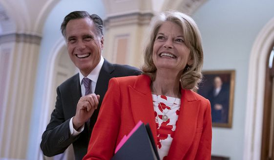 Republican Sens. Lisa Murkowski of Alaska and Mitt Romney of Utah, who say they will vote to confirm Judge Ketanji Brown Jackson&#39;s historic nomination to the Supreme Court, smile as they greet each other outside the chamber, at the Capitol in Washington, Tuesday, April 5, 2022. Murkowski and Romney join Sen. Susan Collins, R-Maine, who is also bucking the GOP leadership in giving President Joe Biden&#39;s nominee a new burst of bipartisan support to become the first Black woman on the high court. (AP Photo/J. Scott Applewhite) ** FILE **