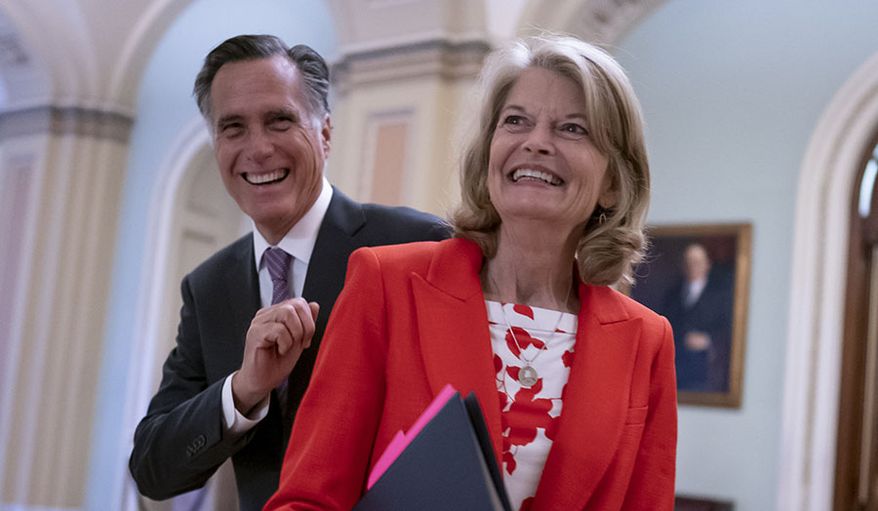 Republican Sens. Lisa Murkowski of Alaska and Mitt Romney of Utah, who say they will vote to confirm Judge Ketanji Brown Jackson&#x27;s historic nomination to the Supreme Court, smile as they greet each other outside the chamber, at the Capitol in Washington, Tuesday, April 5, 2022. Murkowski and Romney join Sen. Susan Collins, R-Maine, who is also bucking the GOP leadership in giving President Joe Biden&#x27;s nominee a new burst of bipartisan support to become the first Black woman on the high court. (AP Photo/J. Scott Applewhite) ** FILE **