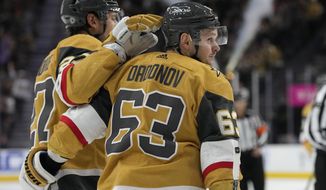 Vegas Golden Knights right wing Evgenii Dadonov (63) celebrates after scoring against the Arizona Coyotes during the second period of an NHL hockey game Saturday, April 9, 2022, in Las Vegas. (AP Photo/John Locher)