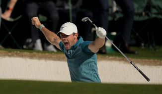 Rory McIlroy, of Northern Ireland, reacts after holing out from the bunker for a birdie during the final round at the Masters golf tournament on Sunday, April 10, 2022, in Augusta, Ga. (AP Photo/Matt Slocum)