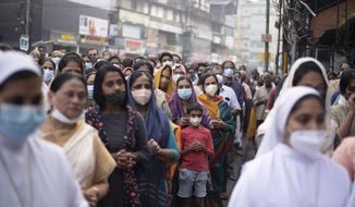 Indian Christians wearing masks as a precaution against COVID-19 gather for prayers as they observe Palm Sunday in Kochi, Kerala state, India, Sunday, April 10, 2022. The South Asian country has recorded a steep dip in coronavirus cases in recent weeks, with the health ministry reporting approximately 1,100 cases on Friday. (AP Photo/R S Iyer)