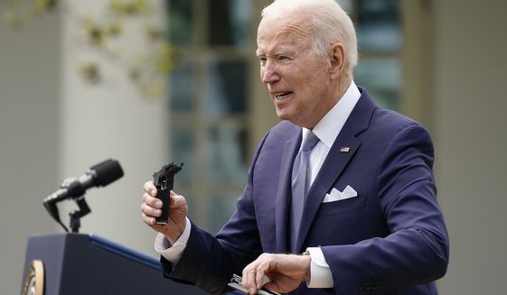 President Joe Biden holds pieces of a 9mm pistol as he speaks in the Rose Garden of the White House in Washington, Monday, April 11, 2022. Biden announced a final version of the administrations ghost gun rule, which comes with the White House and the Justice Department under growing pressure to crack down on gun deaths. (AP Photo/Carolyn Kaster)