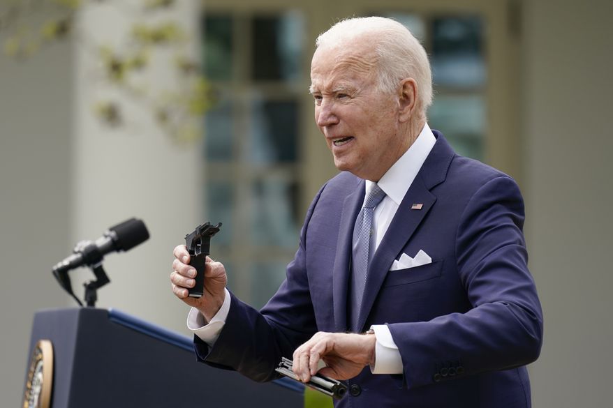 President Joe Biden holds pieces of a 9mm pistol as he speaks in the Rose Garden of the White House in Washington, Monday, April 11, 2022. Biden announced a final version of the administrations ghost gun rule, which comes with the White House and the Justice Department under growing pressure to crack down on gun deaths. (AP Photo/Carolyn Kaster)