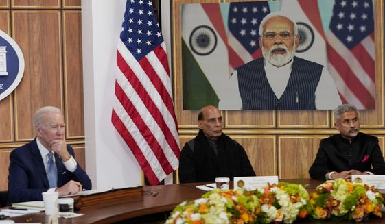 President Joe Biden meets virtually with Indian Prime Minister Narendra Modi in the South Court Auditorium on the White House campus in Washington, Monday, April 11, 2022. India&#39;s Defense minister Rajnath Singh, is center, and India&#39;s foreign minister Subrahmanyam Jaishankar, is right (AP Photo/Carolyn Kaster)
