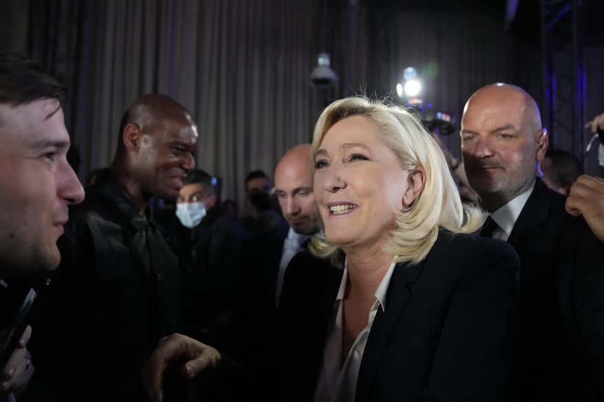 French far-right candidate Marine Le Pen shakes hands with supporters after delivering a speech at her election day headquarters in Paris, Sunday, April 10, 2022. French polling agency projections show incumbent French President Emmanuel Macron and far-right leader Marine Le Pen leading in the first round of France&#39;s presidential election Sunday. (AP Photo/Francois Mori)