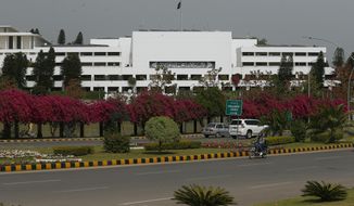 A motorcyclist rides past the National Assembly where the session to choose the new prime minister continues in Islamabad, Pakistan, Monday, April 11, 2022. Pakistani lawmakers are to choose a new prime minister on Monday, capping a tumultuous week of political drama that saw the ouster of Imran Khan as premier and a constitutional crisis narrowly averted after the country&#39;s top court stepped in. (AP Photo/Anjum Naveed)