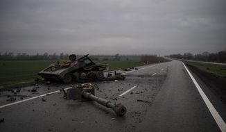 A destroyed self propelled artillery unit is seen on a road near Kharkiv, Ukraine, Tuesday, April 12, 2022. (AP Photo/Felipe Dana)