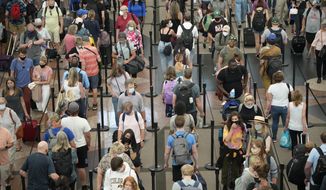 Travelers queue up in long lines to pass through the south security checkpoint in Denver International Airport, Wednesday morning, June 16, 2021, in Denver. (AP Photo/David Zalubowski, File)