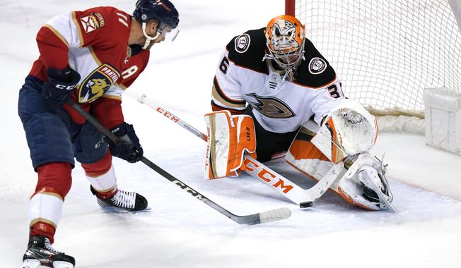Florida Panthers left wing Jonathan Huberdeau (11) sets up a shot to score a goal against Anaheim Ducks goaltender John Gibson during overtime in an NHL hockey game, Tuesday, April 12, 2022, in Sunrise, Fla. The Panthers won 3-2. (AP Photo/Lynne Sladky)