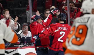 Washington Capitals left wing Alex Ovechkin, left, and defenseman Justin Schultz celebrate Ovechkin&#39;s goal during the first period of the team&#39;s NHL hockey game against the Philadelphia Flyers, Tuesday, April 12, 2022, in Washington. (AP Photo/Alex Brandon)
