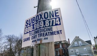 A sign advertising addiction treatment is posted to a utility pole in Huntington, W.Va., Friday, March 19, 2021. The influx of prescription opioids into West Virginia communities was the main driver of the state&#39;s drug crisis, more than poverty, job loss and other economic stressors, an epidemiologist testified Tuesday, April 12, 2022, at the ongoing trial against three major pharmaceutical companies. (AP Photo/David Goldman, File).