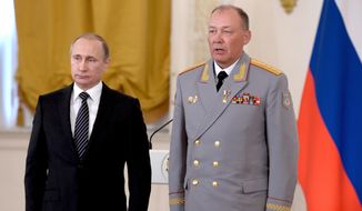 In this file photo, Russian President Vladimir Putin, left, poses with Col. Gen. Alexander Dvornikov during an awarding ceremony in Moscow&#x27;s Kremlin, Russia on March 17, 2016. Dvornikov was appointed the new military commander for the campaign in Ukraine. (Alexei Nikolsky/Sputnik, Kremlin Pool Photo via AP)  ** FILE **