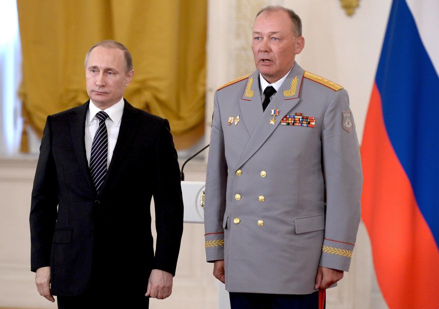 In this file photo, Russian President Vladimir Putin, left, poses with Col. Gen. Alexander Dvornikov during an awarding ceremony in Moscow&#x27;s Kremlin, Russia on March 17, 2016. Dvornikov was appointed the new military commander for the campaign in Ukraine. (Alexei Nikolsky/Sputnik, Kremlin Pool Photo via AP)  ** FILE **