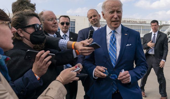 President Joe Biden speaks to the media before boarding Air Force One at Des Moines International Airport, in Des Moines Iowa, Tuesday, April 12, 2022, en route to Washington.  Biden said that Russia&#x27;s war in Ukraine amounted to a &quot;genocide,&quot; accusing President Vladimir Putin of trying to &quot;wipe out the idea of even being a Ukrainian.&quot; (AP Photo/Carolyn Kaster)