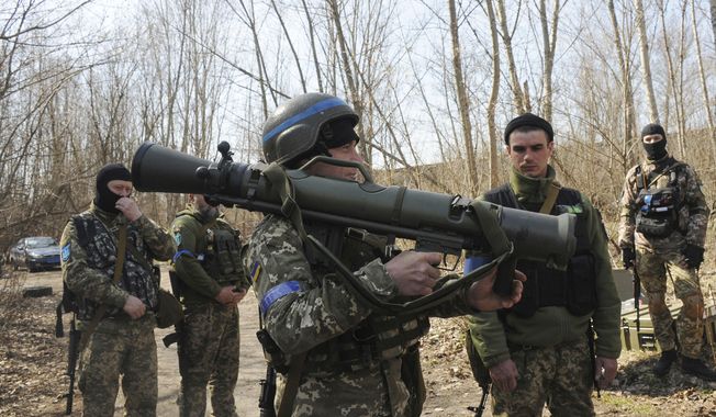 Ukrainian servicemen study a Sweden shoulder-launched weapon system Carl Gustaf M4 during a training session on the near Kharkiv, Ukraine, April 7, 2022. Western weaponry pouring into Ukraine helped blunt Russia&#x27;s initial offensive and seems certain to play a central role in the approaching battle for Ukraine&#x27;s contested Donbas region. Yet the Russian military is making little headway halting what has become a historic arms express. (AP Photo/Andrew Marienko, File)