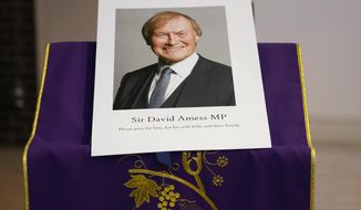 FILE - In this Friday, Oct. 15, 2021 file photo, an image of murdered British Conservative lawmaker David Amess is displayed near the altar in St Peters Catholic Church before a vigil in Leigh-on-Sea, Essex, England. A jury deliberated for just 18 minutes Monday before finding a fervent Islamic State supporter guilty of stabbing lawmaker David Amess to death a slaying that shocked the nation and sparked calls for increased police protection for politicians. Ali Harbi Ali, 26, was found guilty by London’s Central Criminal Court of murder and preparing terrorist acts. (AP Photo/Alberto Pezzali, File)