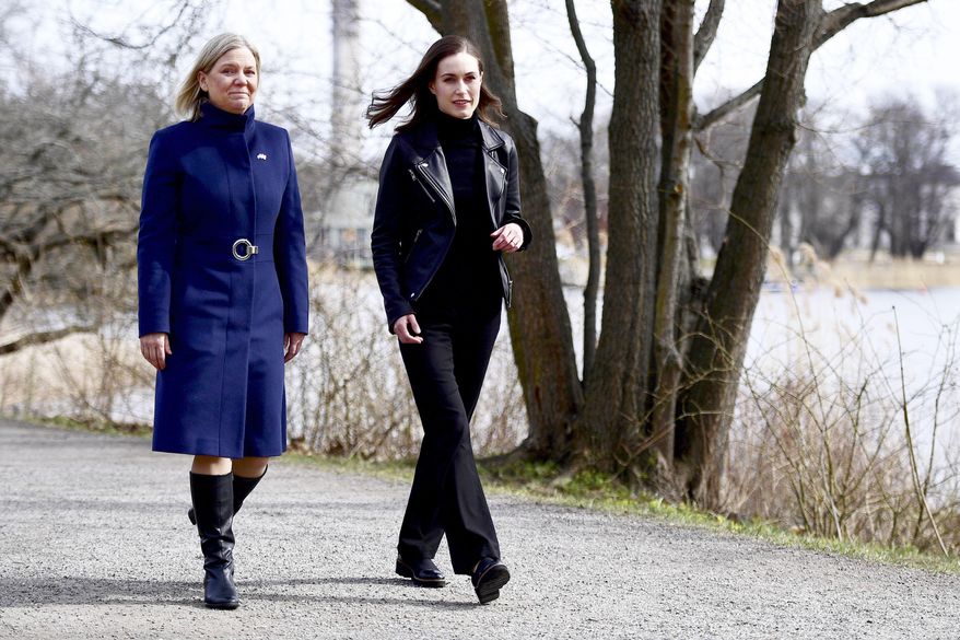 Swedish Prime Minister Magdalena Andersson, left, and Finnish Prime Minister Sanna Marin walk together prior to a meeting on whether to seek NATO membership, in Stockholm, Sweden, Wednesday, April 13, 2022. (Paul Wennerholm/TT via AP)