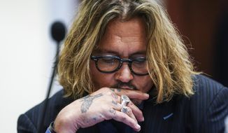 Actor Johnny Depp sits in the courtroom at the Fairfax County Circuit Courthouse in Fairfax, Va., Thursday, April 14, 2022.  Actor Johnny Depp sued his ex-wife Amber Heard for libel in Fairfax County Circuit Court after she wrote an op-ed piece in The Washington Post in 2018 referring to herself as a “public figure representing domestic abuse.” (Shawn Thew/Pool Photo via AP)