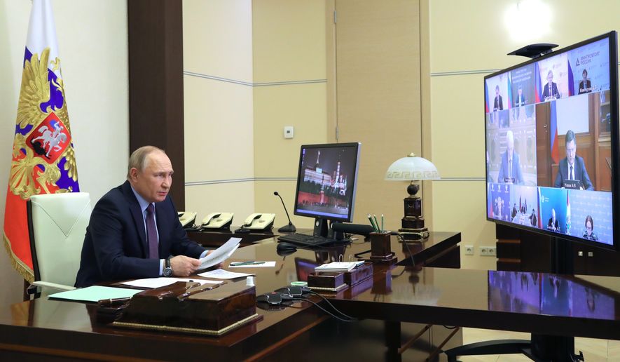 Russian President Vladimir Putin chairs a meeting on the situation in the oil and gas sector via videoconference at the Novo-Ogaryovo residence outside Moscow, Russia, Thursday, April 14, 2022. (Mikhail Klimentyev, Sputnik, Kremlin Pool Photo via AP)