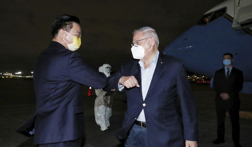 In this photo released by Taiwan&#x27;s Ministry of Foreign Affairs, Taiwan&#x27;s Foreign Minister Joseph Wu, left, greets Sen. Bob Menendez, D-N.J., as he arrives in Taipei, Taiwan, Thursday, April 14, 2022. A delegation of six U.S. lawmakers led by Republican Lindsey Graham from South Carolina arrived in Taiwan on Thursday for a two-day visit that has already been denounced by China. (Taiwan Ministry of Foreign Affairs via AP)