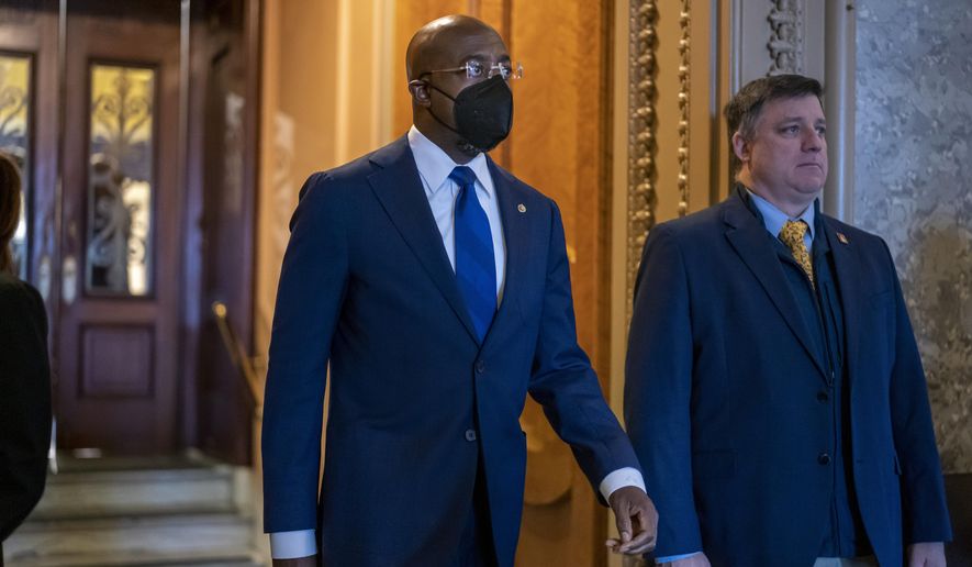 FILE— Sen. Raphael Warnock, D-Ga., leaves the Senate chamber at the Capitol in Washington on April 7, 2022. Warnock’s reelection campaign announced on Thursday, April 14, 2022 that it raised $13.6 million in the first three months of 2022, what the campaign says is the most money ever raised by a U.S. Senate candidate in the first quarter of an election year. (AP Photo/J. Scott Applewhite)