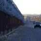 A U.S. Border Patrol vehicle drives along the border fence at the U.S.-Mexico border wall, on Dec. 15, 2020, in Douglas, Ariz., in this file photo. (AP Photo/Ross D. Franklin, File)  **FILE**