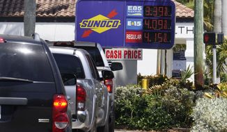 Cars line up at a Sunoco gas station offering high-level ethanol-gasoline blends at a cost below regular gasoline, Wednesday, April 13, 2022, in Delray Beach, Fla.   (AP Photo/Marta Lavandier)