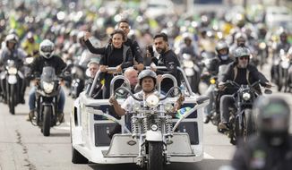 Supporters of Brazil&#39;s President Jair Bolsonaro take part in a caravan of thousands of motorcycle enthusiasts who gathered in a show of support for him in Sao Paulo, Brazil, Friday, April 15, 2022. (AP Photo/Andre Penner)