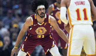 Cleveland Cavaliers&#39; Jarrett Allen (31) defends Atlanta Hawks Trae Young (11) during the first half of an NBA play-in basketball game Friday, April 15, 2022, in Cleveland. (AP Photo/Nick Cammett)