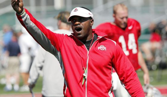 FILE - Then-Ohio State receivers coach Stan Drayton calls out to players during NCAA college football practice in Columbus, Ohio, Aug. 16, 2011. New Temple coach Stan Drayton is one of 15 Black head coaches currently set to start next season at 131 FBS schools.  (AP Photo/Terry Gilliam, File)