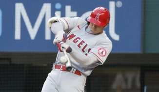 Los Angeles Angels&#39; Shohei Ohtani hits a solo home run against the Texas Rangers during the first inning of a baseball game, Friday, April 15, 2022, in Arlington, Texas. (AP Photo/Michael Ainsworth)