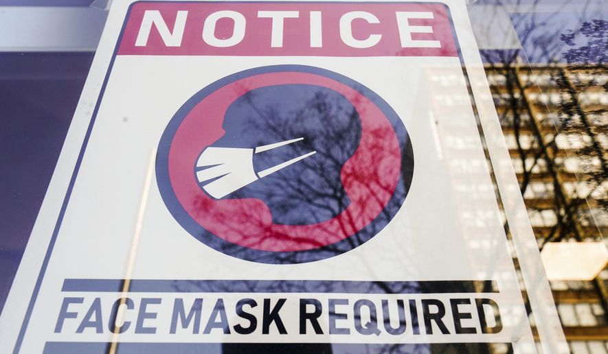 A sign requiring masks as a precaution against the spread of the coronavirus on a store front in Philadelphia, is seen Feb. 16, 2022. Philadelphia is reinstating its indoor mask mandate after reporting a sharp increase in coronavirus infections, Dr. Cheryl Bettigole, the city&#39;s top health official, announced Monday, April 11, 2022. Confirmed COVID-19 cases have risen more than 50% in 10 days, the threshold at which the city&#39;s guidelines call for people to wear masks indoors. (AP Photo/Matt Rourke, File)