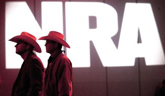 National Rifle Association members listen to speakers during the NRA&#39;s annual Meetings and Exhibits at the George R. Brown Convention Center in Houston, in this May 4, 2013, file photo. (Johnny Hanson/Houston Chronicle via AP, File)